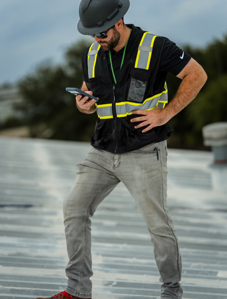 Wade Coons, owner of Coons Roofing, on a commercial roof in Houston